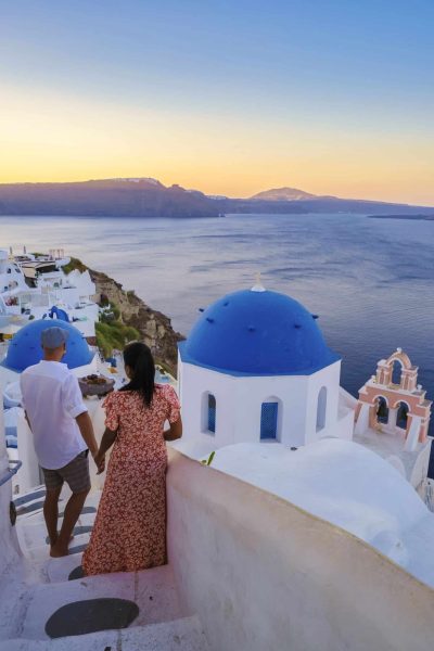 Couple on vacation in Santorini Greece, men, and women on the streets of the Greek village of Oia Santorini
