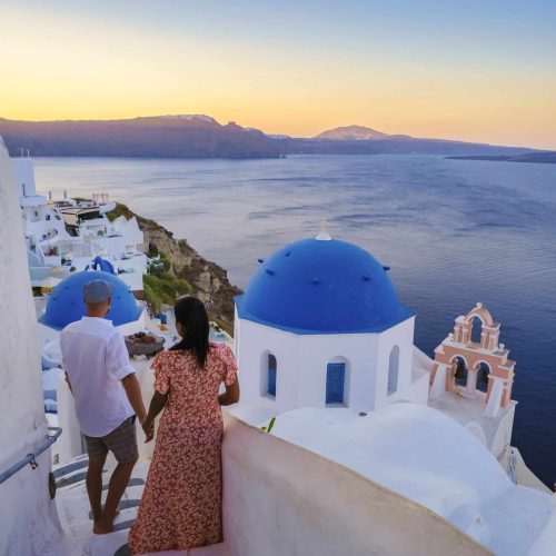 Couple on vacation in Santorini Greece, men, and women on the streets of the Greek village of Oia Santorini