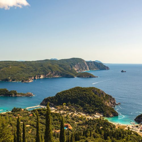 Kerkyra (Corfu) town Corfu Island in Ionian sea. Greece. Beautiful landscape with green trees, hills and sean water in sunny day.