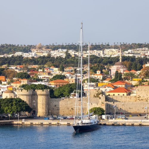 Sailboat near Historic Old Town in City on the Mediterranean Sea, Rhodes, Greece.